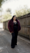 A model in a vintage faux fur shag coat in size large