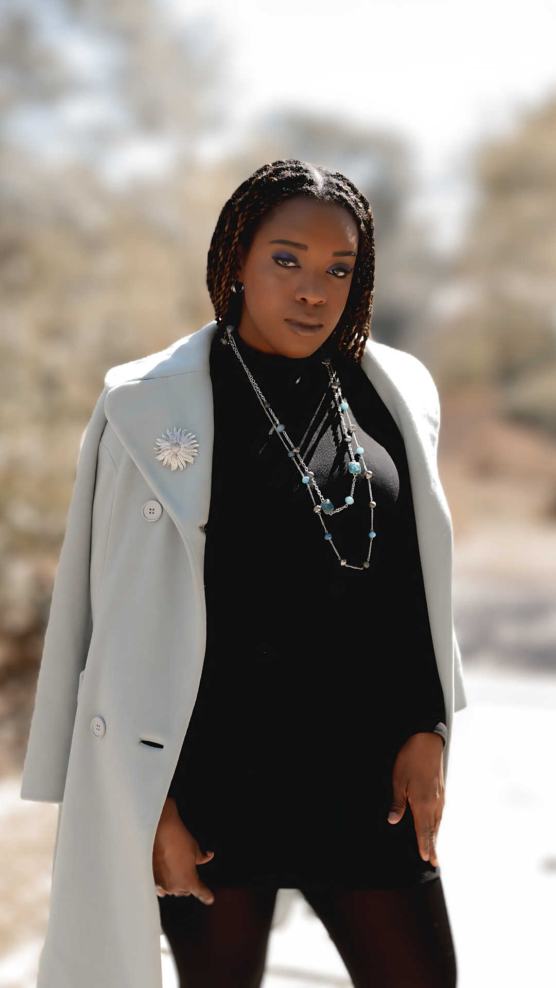 Model in a vintage belted cool blue trench in a size small