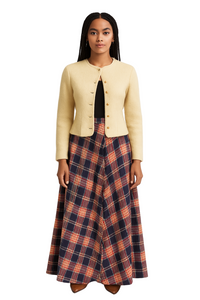 Woman wearing a beige jacket and plaid skirt on a white background
