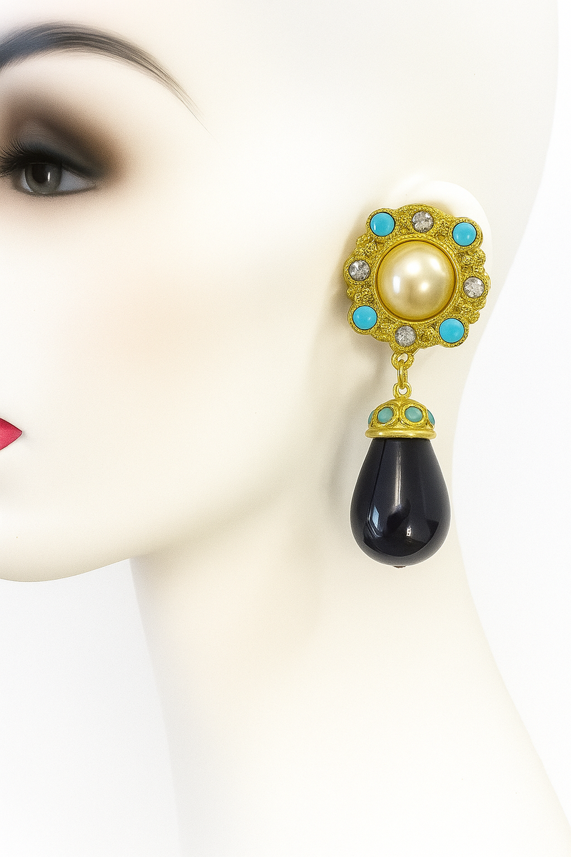 Stunning statement earrings featuring a luminous faux pearl centerpiece
